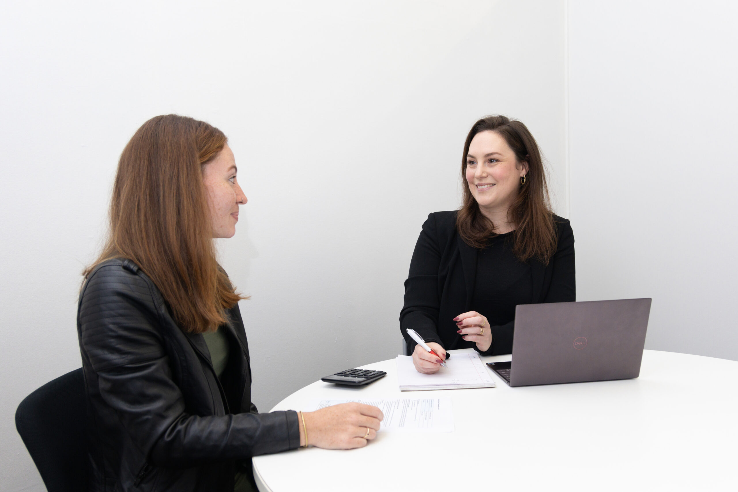 Two people reviewing documents at a desk